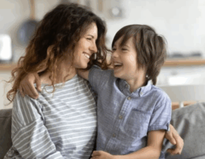 Mother and young son laughing together